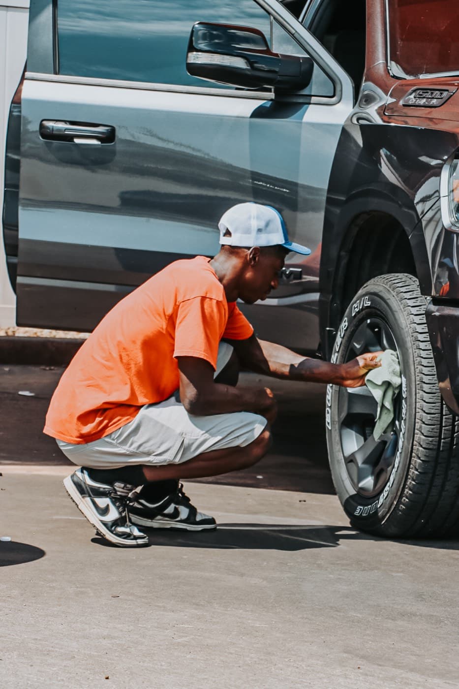 A wheel and tire being detailed by hand